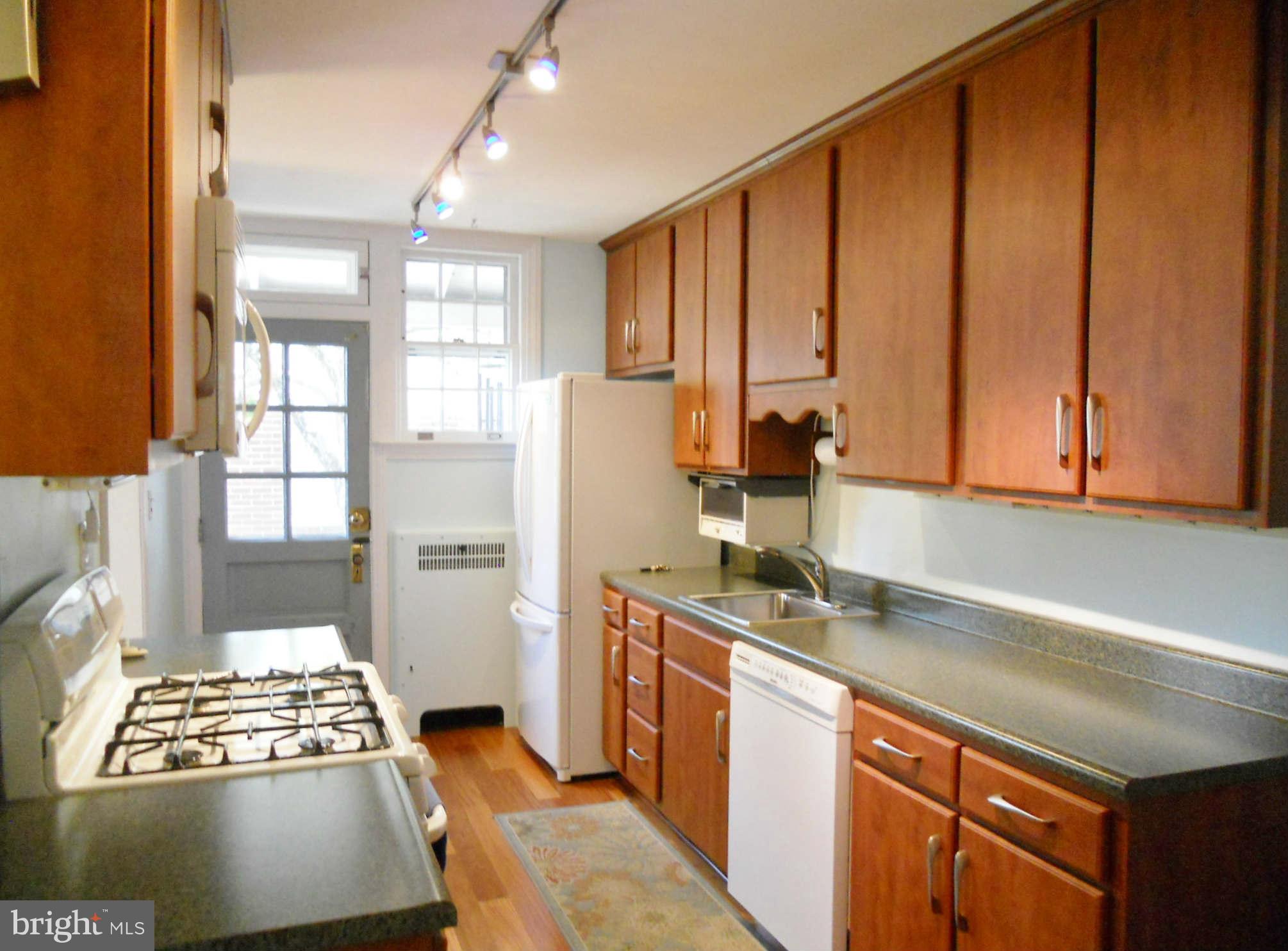 313 Murdock Road Baltimore, MD 21212 - Photo 6 of 15 a kitchen with stainless steel appliances a refrigerator and cabinets