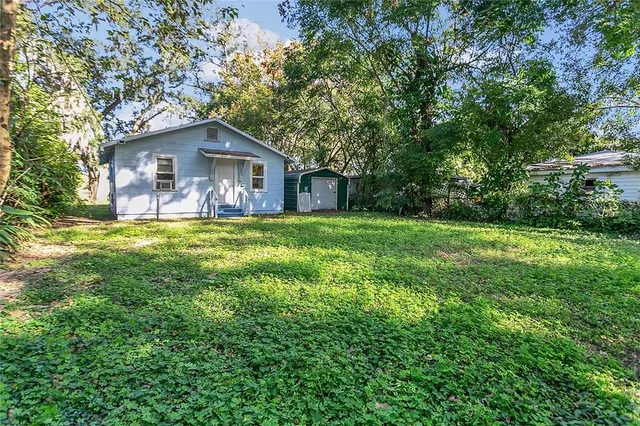an aerial view of residential houses with outdoor space and swimming pool
