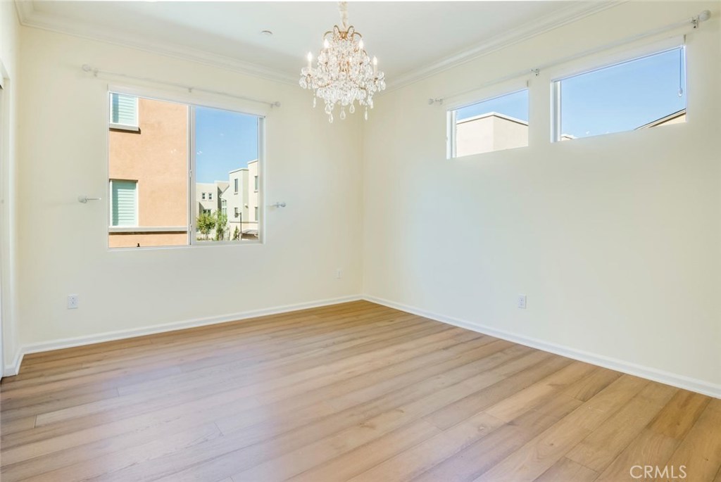 5439 Strand, Unit 101 Hawthorne, CA 90250 - Photo 12 of 23 a view of an empty room with wooden floor and a chandelier