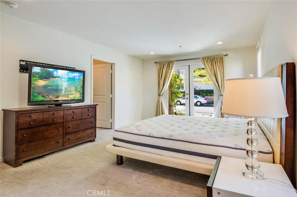 5439 Strand, Unit 101 Hawthorne, CA 90250 - Photo 14 of 23 a bedroom with a bed and a flat screen television