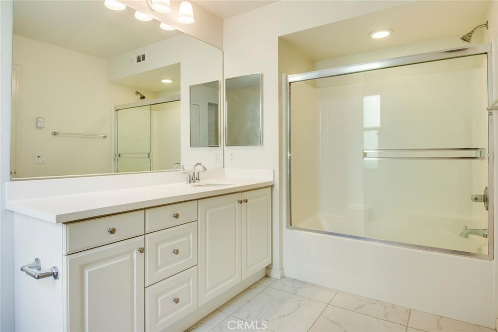 5439 Strand, Unit 101 Hawthorne, CA 90250 - Photo 16 of 23 a bathroom with a shower sink and mirror