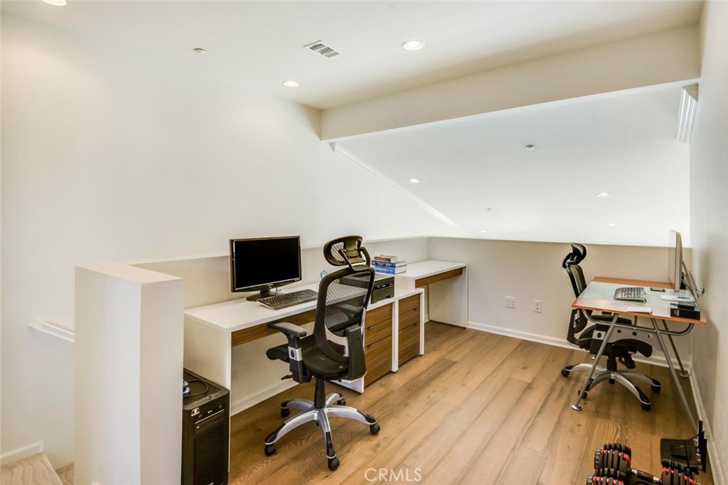 5439 Strand, Unit 101 Hawthorne, CA 90250 - Photo 17 of 23 a view of a workspace with furniture and wooden floor