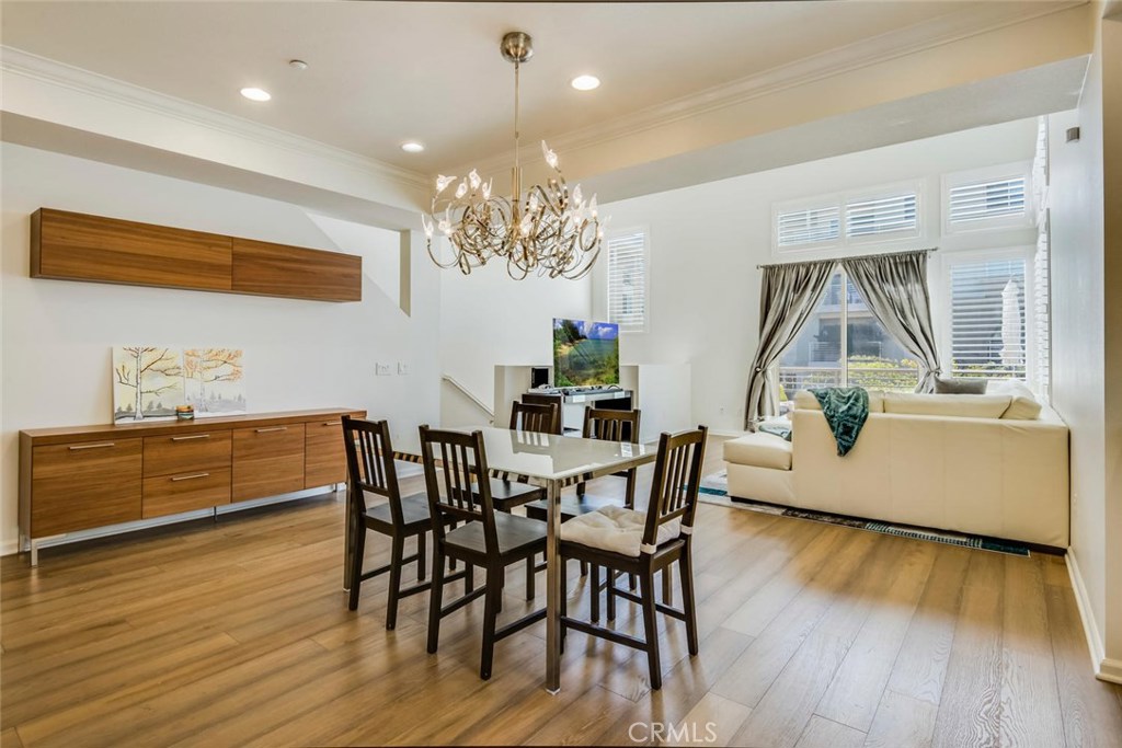 5439 Strand, Unit 101 Hawthorne, CA 90250 - Photo 4 of 23 a view of a dining room with furniture wooden floor and chandelier