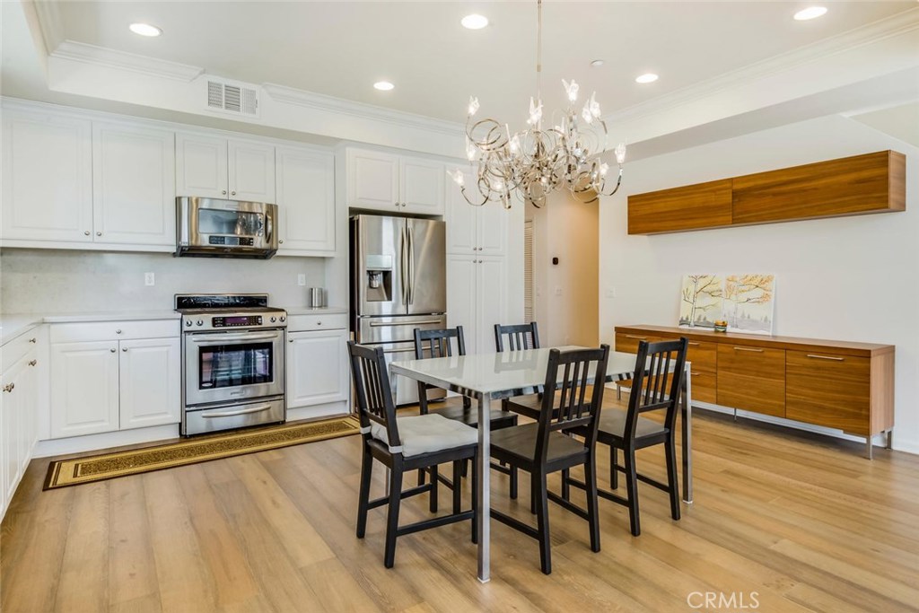 5439 Strand, Unit 101 Hawthorne, CA 90250 - Photo 5 of 23 a view of a dining room with furniture and wooden floor