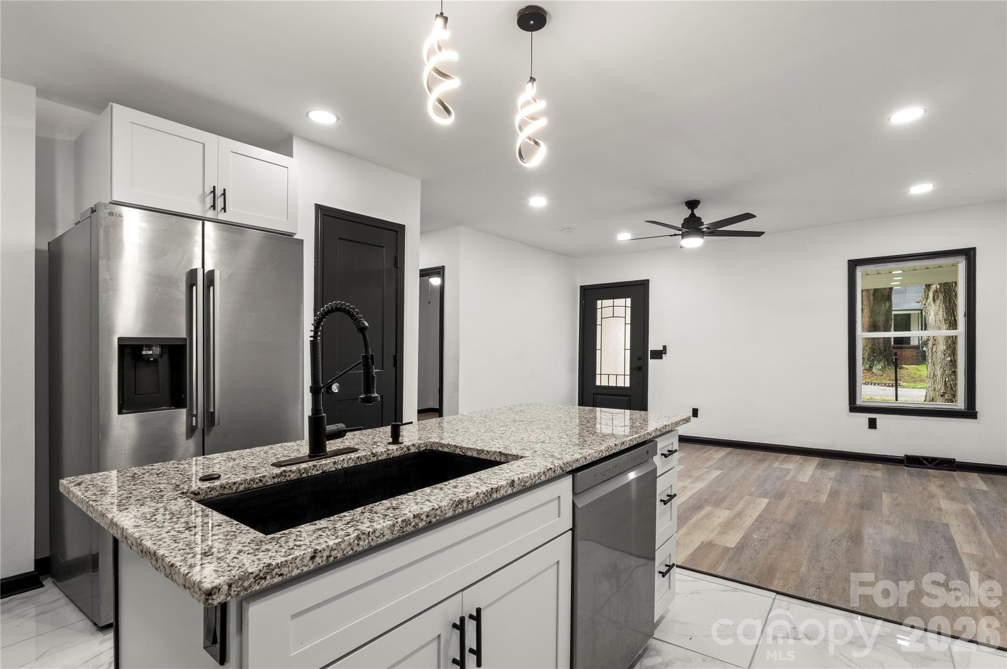 110 Courtland Street Chester, SC 29706 - Photo 4 of 22 a kitchen with kitchen island granite countertop a sink and refrigerator