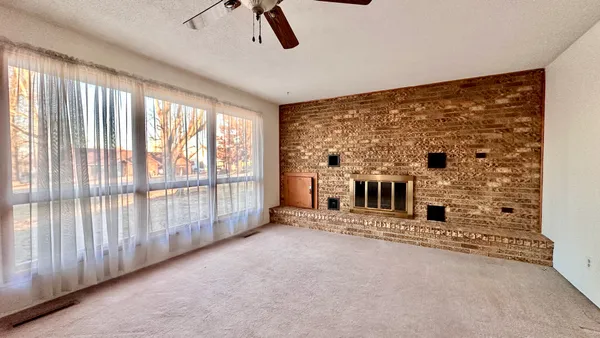 a view of a big room with windows