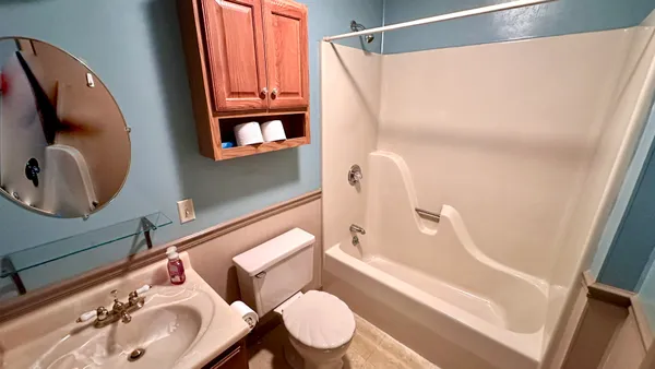 a bathroom with a sink toilet and mirror