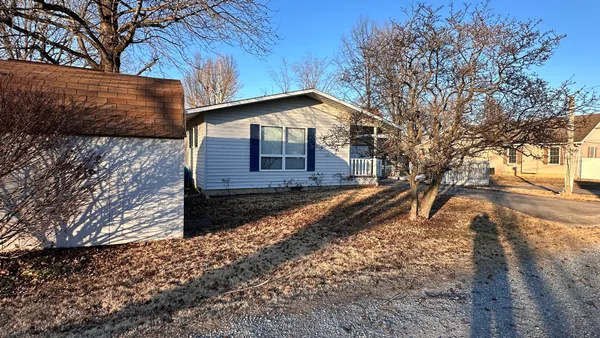 a view of a house with a yard covered with snow
