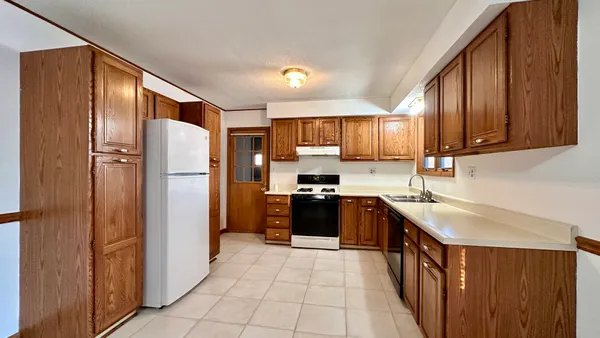 a kitchen with stainless steel appliances granite countertop a refrigerator stove and sink