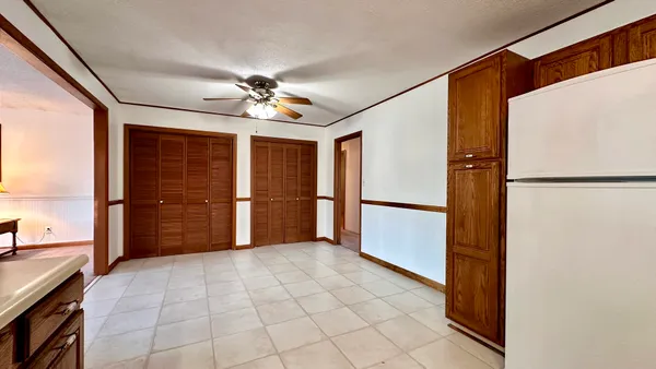 a view of empty room with a kitchen