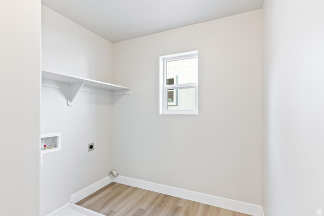 387 Slant Road, Unit 30 Spanish Fork, UT 84660 - Photo 12 of 25 Utility area featuring a single window, a built-in shelf, and wood-finish flooring