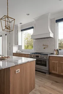 a kitchen with stainless steel appliances granite countertop a stove a sink and a granite counter tops