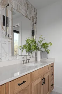 a bathroom with a sink a vanity and a mirror