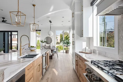 a kitchen with sink stove and cabinets