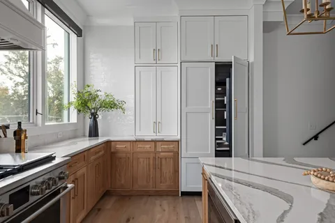 a kitchen with stainless steel appliances a sink stove and cabinets