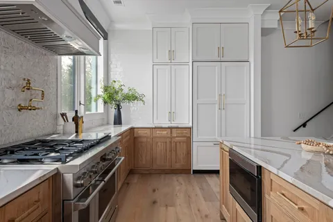 a kitchen with granite countertop a sink stove and cabinets