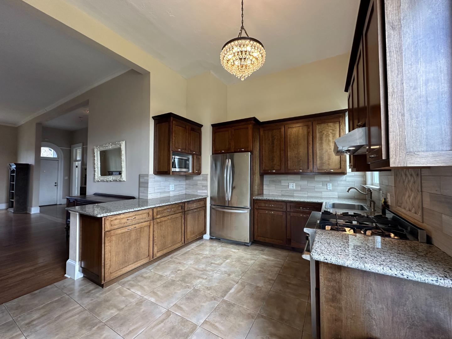 69 Geil Street Salinas, CA 93901 - Photo 14 of 34 a kitchen with stainless steel appliances granite countertop a sink stove and refrigerator