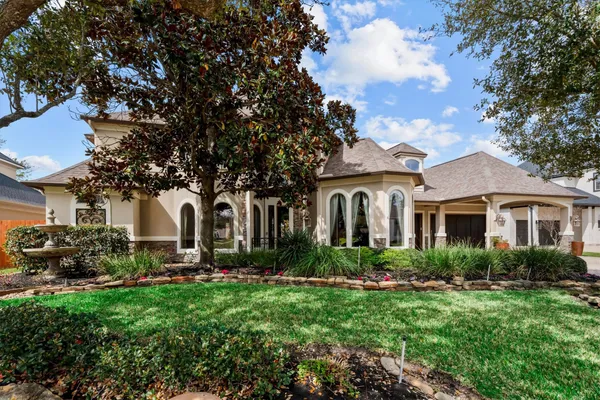 a front view of house with yard and green space