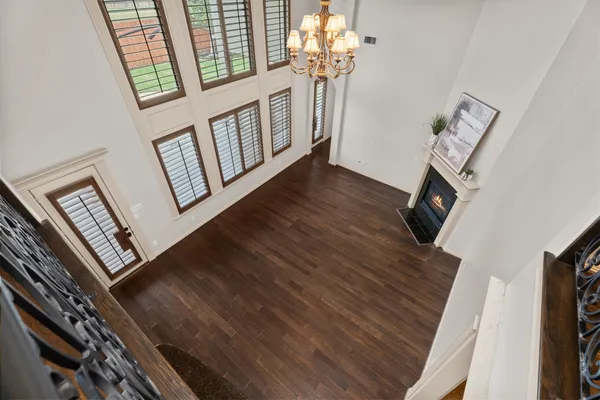 a living room with furniture and a chandelier