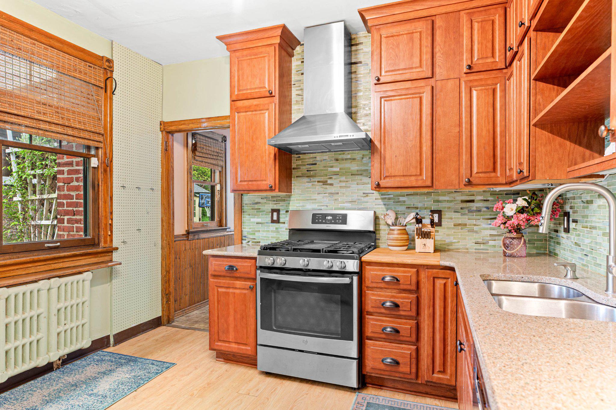 7602 Spring Avenue Elkins Park, PA 19027 - Photo 22 of 50 a kitchen with stainless steel appliances granite countertop a stove and a sink