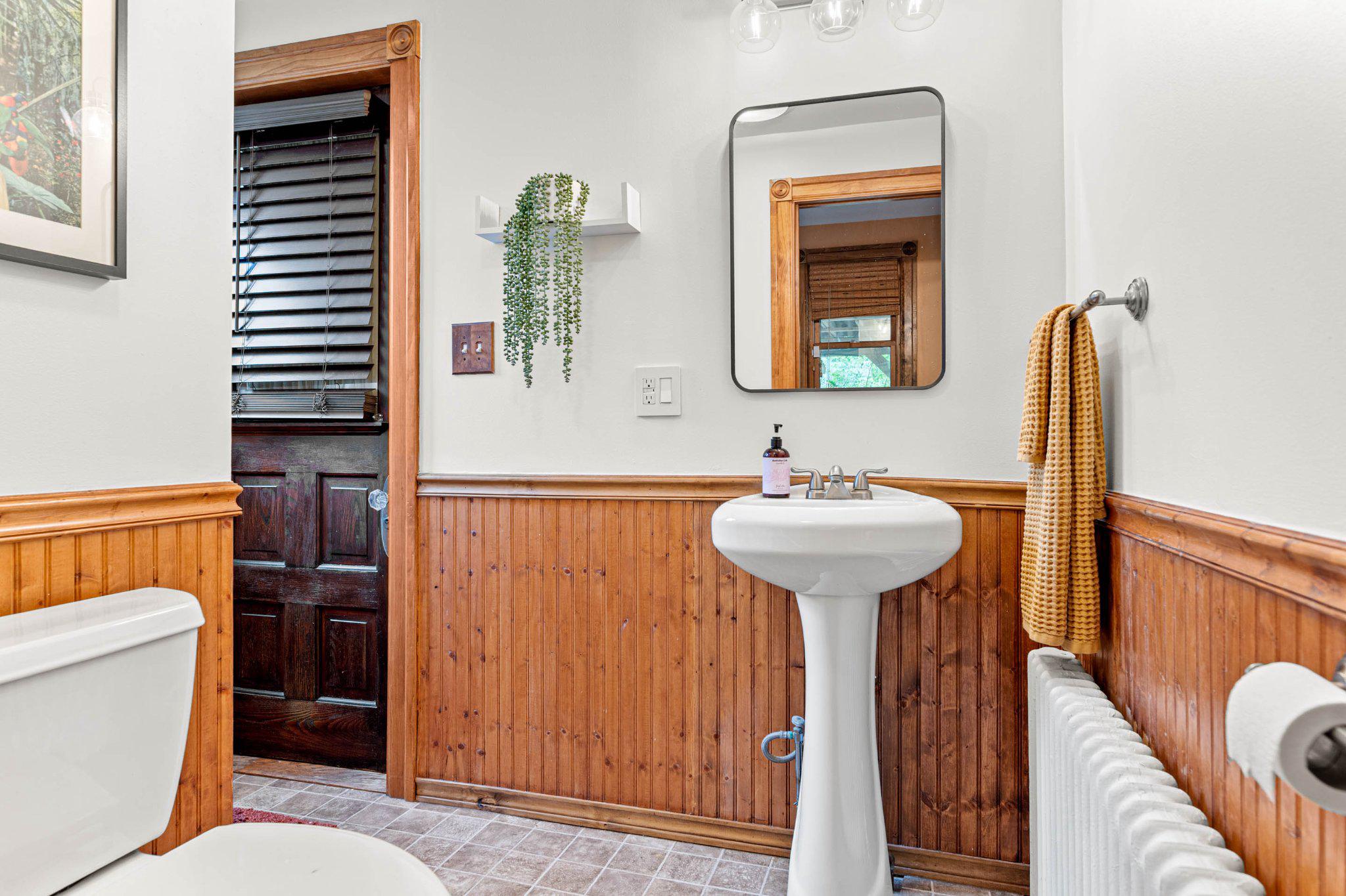 7602 Spring Avenue Elkins Park, PA 19027 - Photo 25 of 50 a bathroom with a sink a mirror a toilet and a window