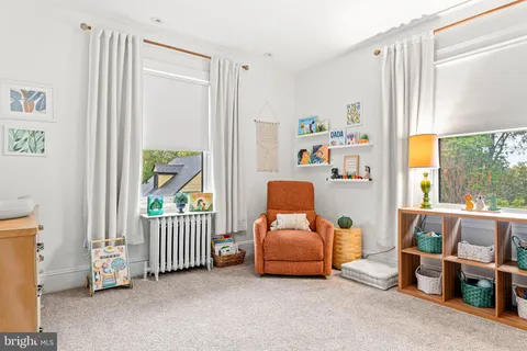 a view of a bedroom with furniture and window