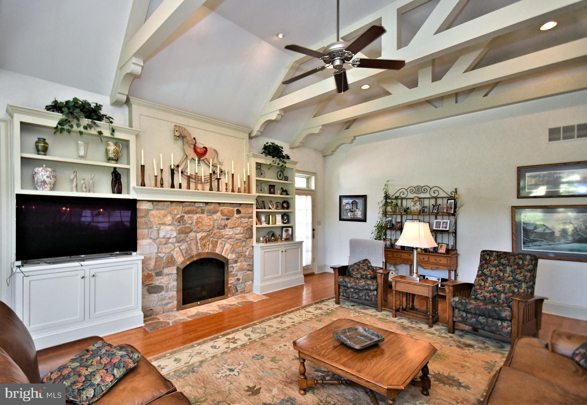 1811 Hollow Road Lansdale, PA 19446 - Photo 36 of 130 a living room with furniture a flat screen tv and a fireplace