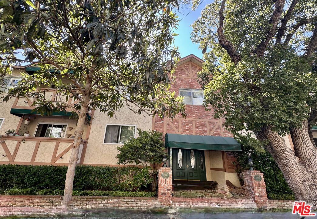 12030 Rochester Avenue, Unit 207 Los Angeles, CA 90025 - Photo 1 of 12 a front view of a house with garden