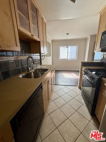 a kitchen with a sink and a stove top oven