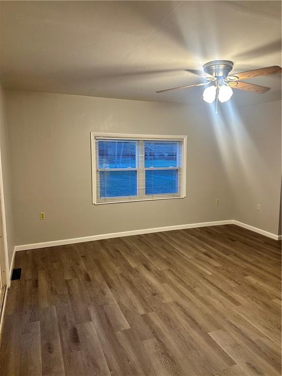 611 Mercer Road Beaver Falls, PA 15010 - Photo 11 of 32 a view of an empty room with wooden floor and a window