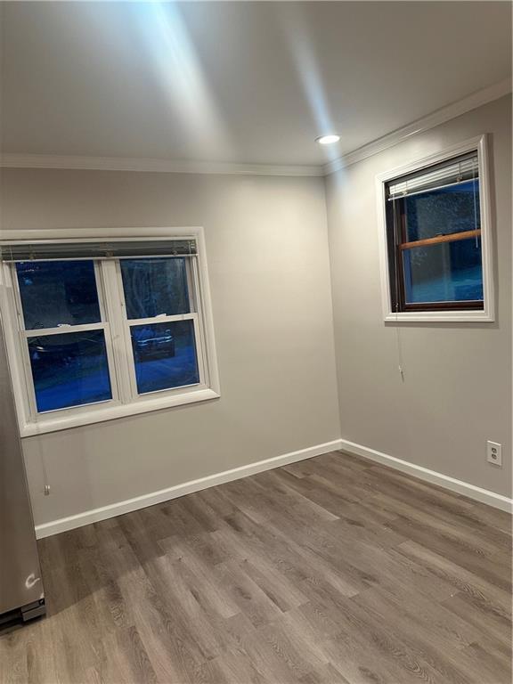 611 Mercer Road Beaver Falls, PA 15010 - Photo 8 of 32 a view of an empty room with wooden floor and a window