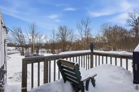 a view of a house with a yard covered in snow