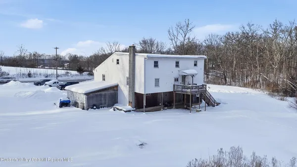 a view of a house with a snow in the yard