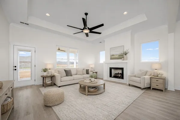 an empty room with windows and fireplace