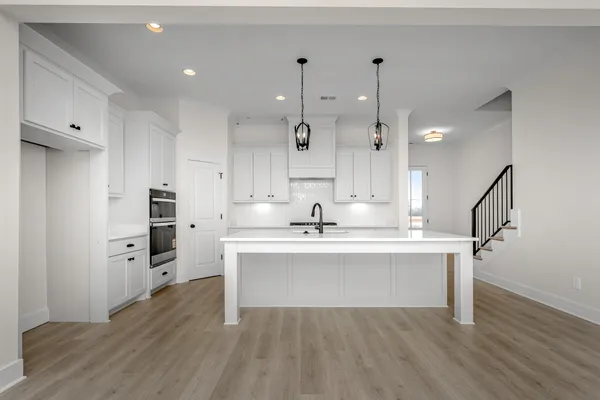 a large kitchen with stainless steel appliances granite countertop a stove sink and cabinets