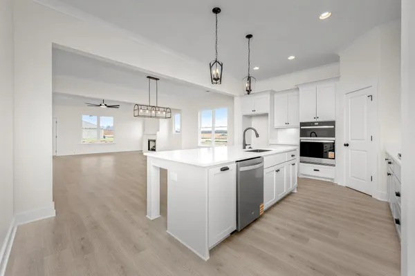 a view of kitchen with stainless steel appliances granite countertop living room and living room