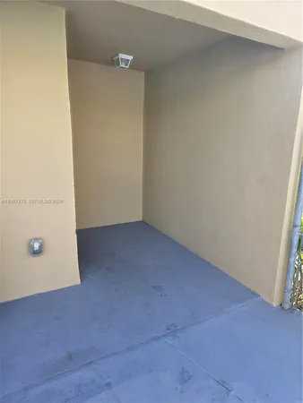 a dining room with furniture and a large window