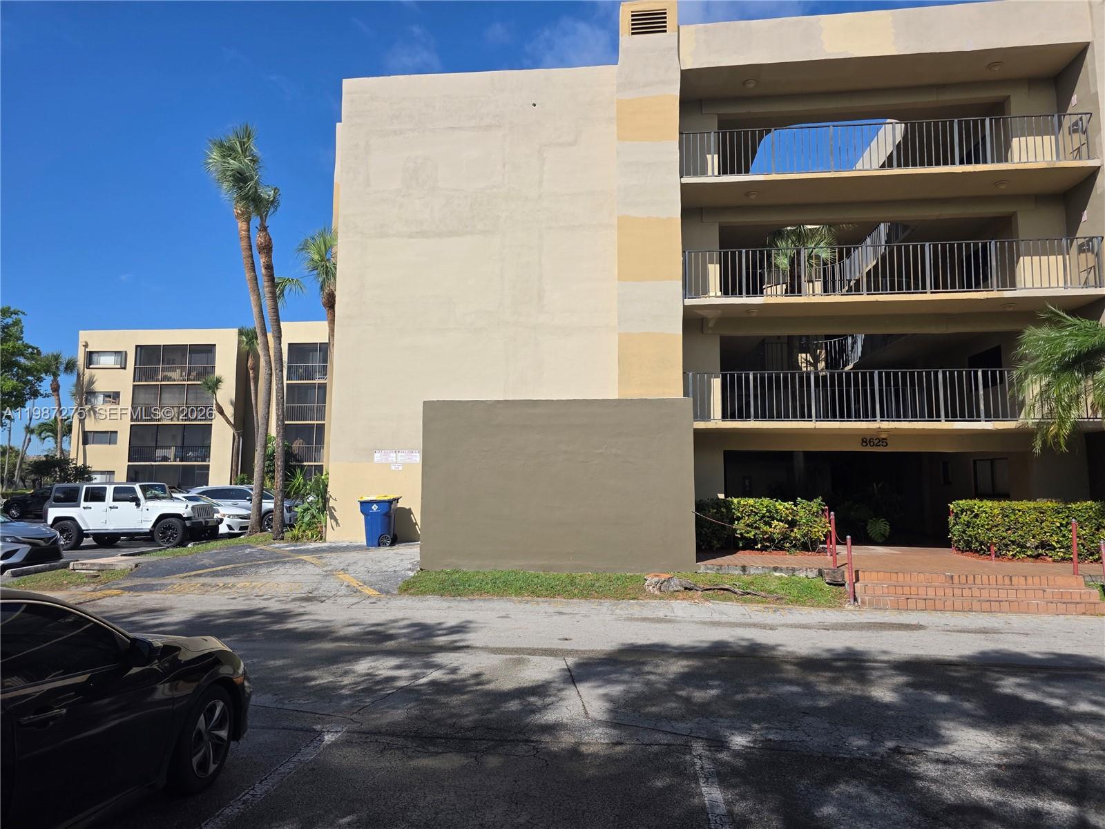 8615 Northwest 8th Street, Unit 319 Miami, FL 33126 - Photo 2 of 19 a view of a street with cars