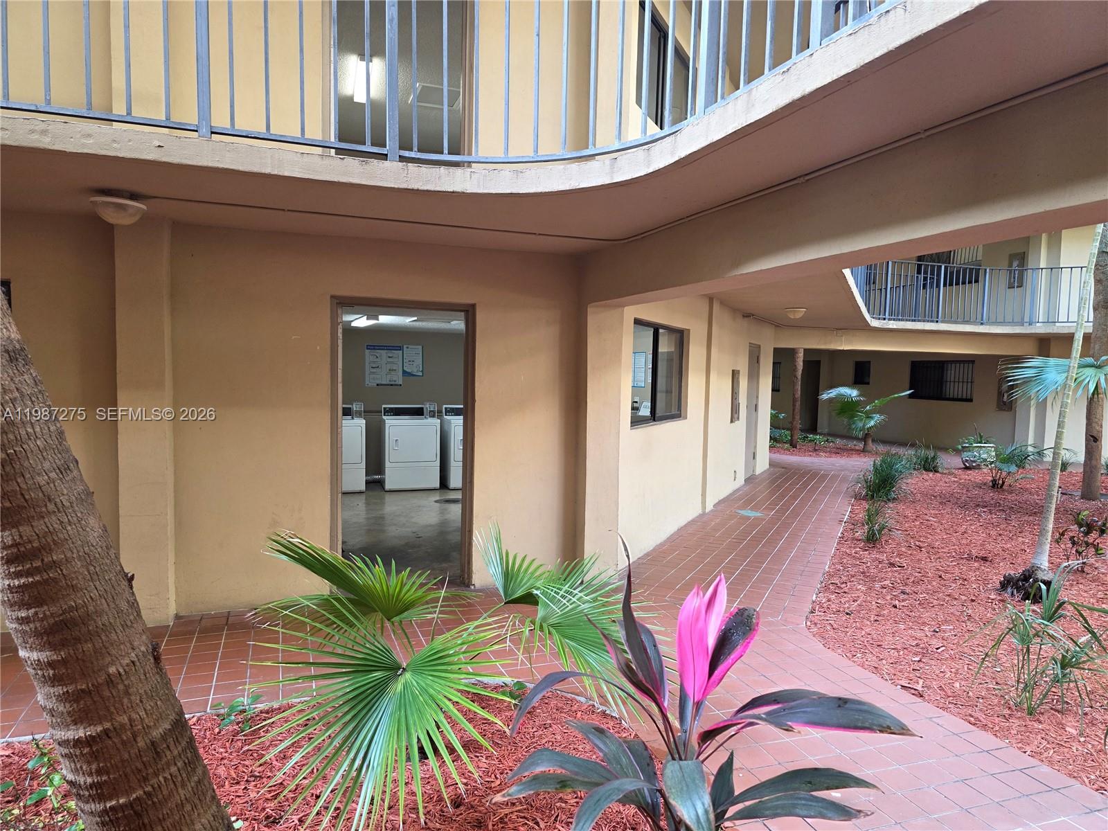 8615 Northwest 8th Street, Unit 319 Miami, FL 33126 - Photo 7 of 19 a front view of a house with balcony