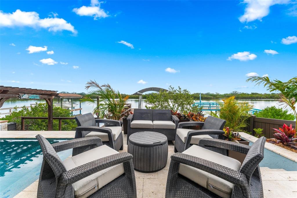 29 Pelican Lane Edgewater, FL 32141 - Photo 24 of 39 a view of a patio with couches chairs potted plants and a table