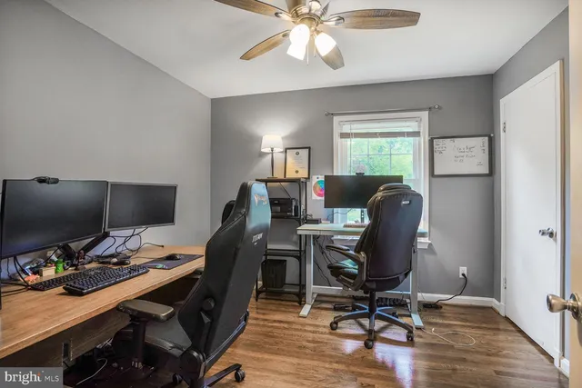 a view of a workspace with furniture and a window
