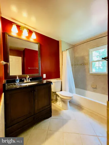 a bathroom with a sink a large mirror and a bathtub