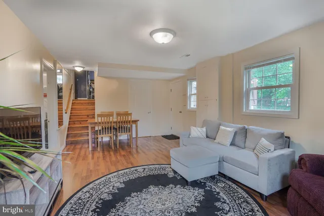a living room with furniture and wooden floor