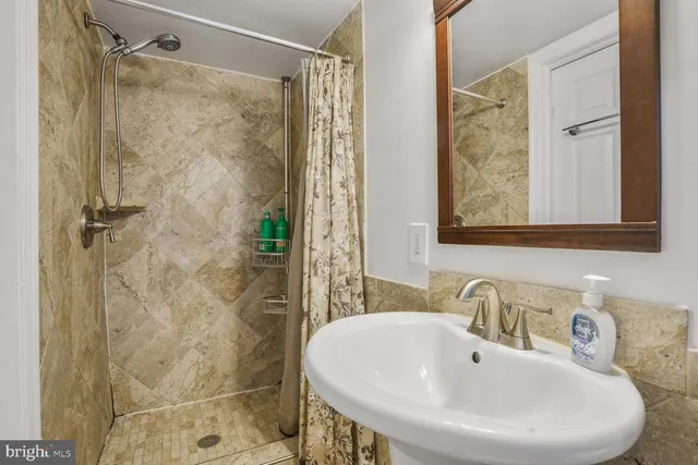 a bathroom with a sink and shower