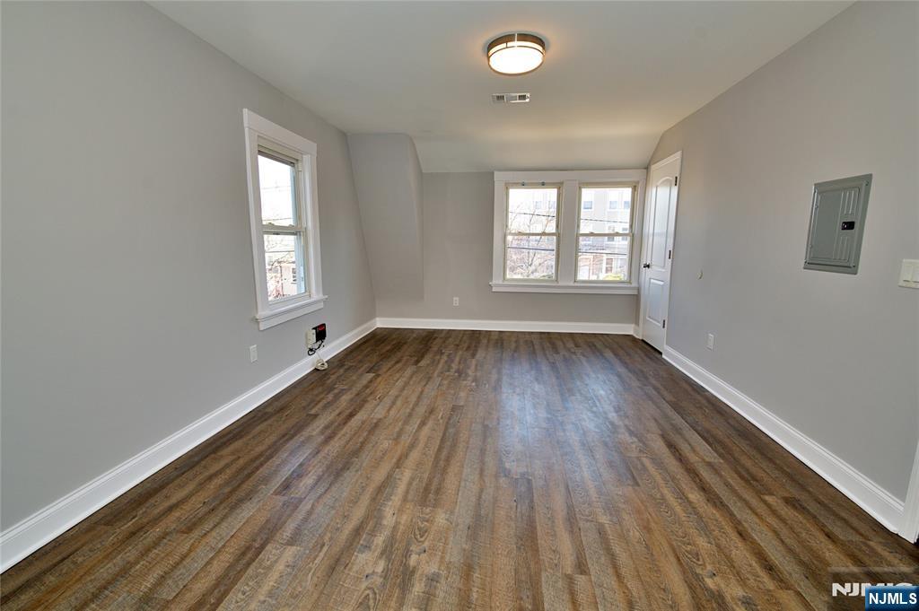 116 Maple Avenue, Unit 3 Montclair, NJ 07042 - Photo 4 of 12 a view of an empty room with wooden floor and a window