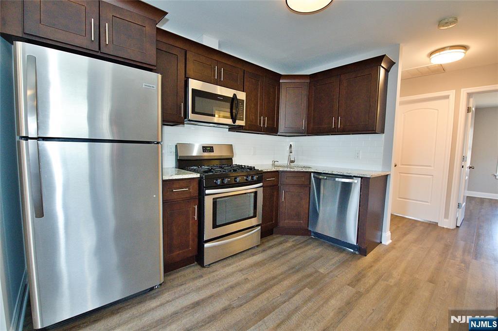 116 Maple Avenue, Unit 3 Montclair, NJ 07042 - Photo 6 of 12 a kitchen with stainless steel appliances a refrigerator stove and microwave