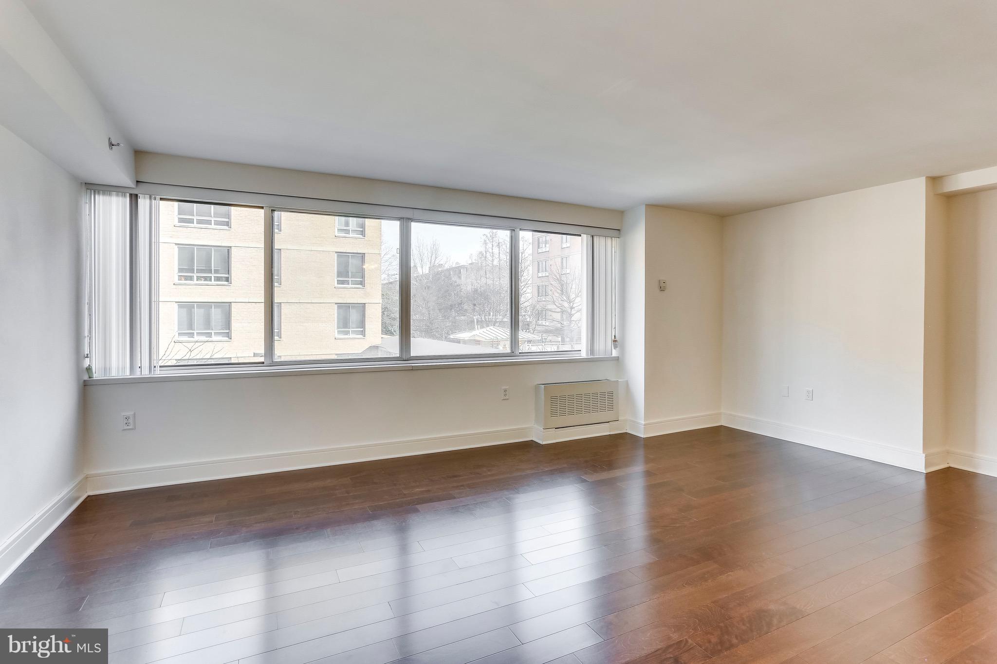 800 4th Street Southwest, Unit N111 Washington, DC 20024 - Photo 12 of 35 an empty room with wooden floor and windows