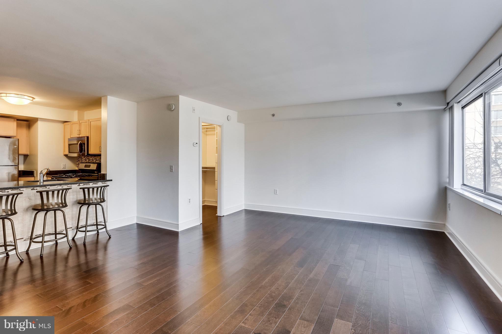 800 4th Street Southwest, Unit N111 Washington, DC 20024 - Photo 19 of 35 a view of a livingroom with furniture hardwood floor and a kitchen