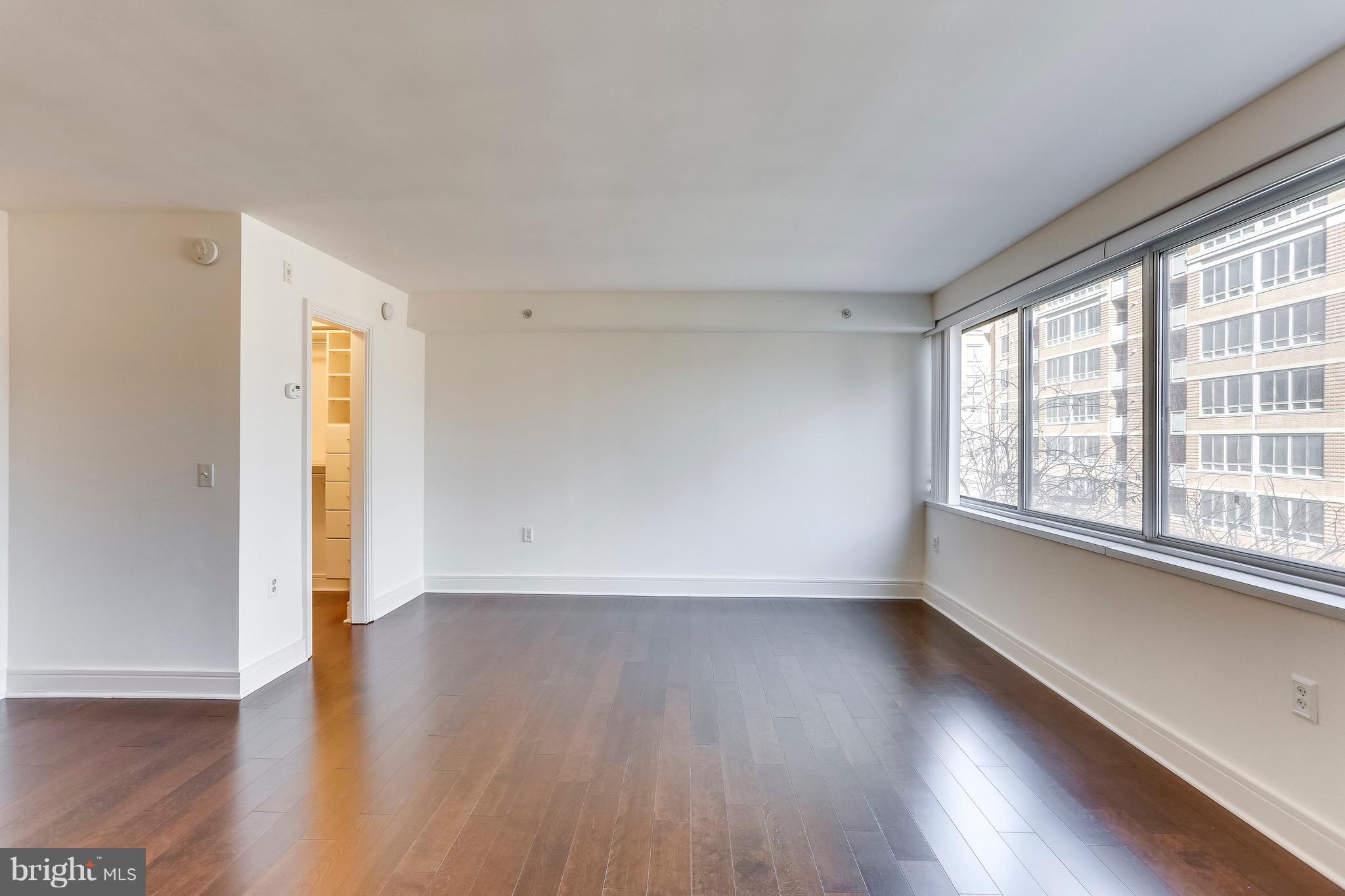 800 4th Street Southwest, Unit N111 Washington, DC 20024 - Photo 21 of 35 an empty room with wooden floor and windows