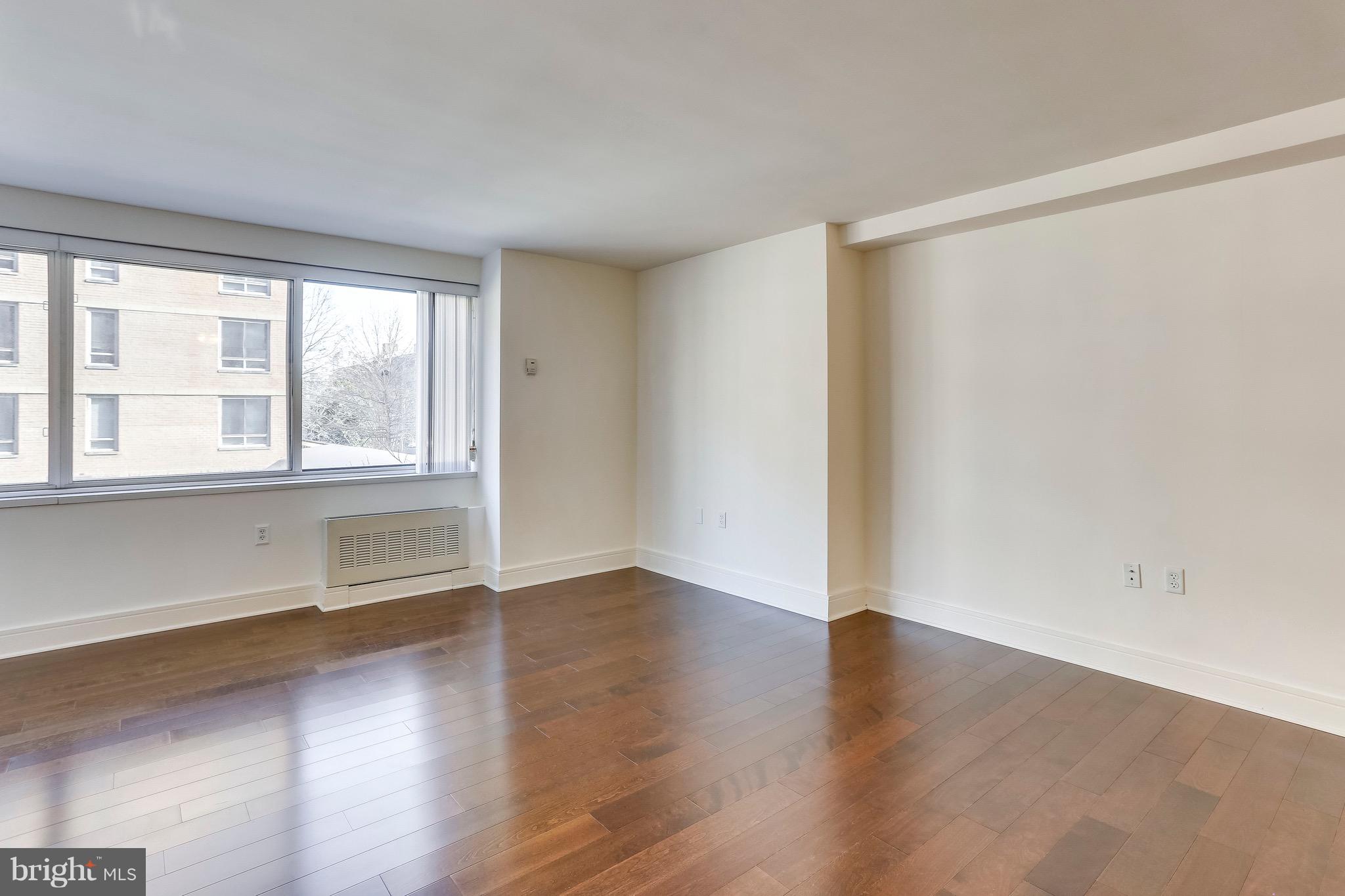800 4th Street Southwest, Unit N111 Washington, DC 20024 - Photo 24 of 35 an empty room with wooden floor and windows